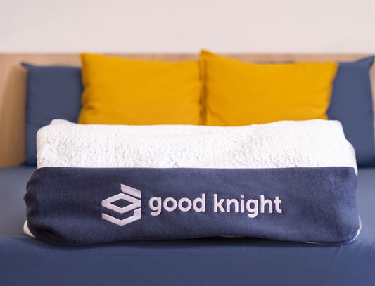 Close up photo of folded Good Knight Athena Mattress Cover on bed