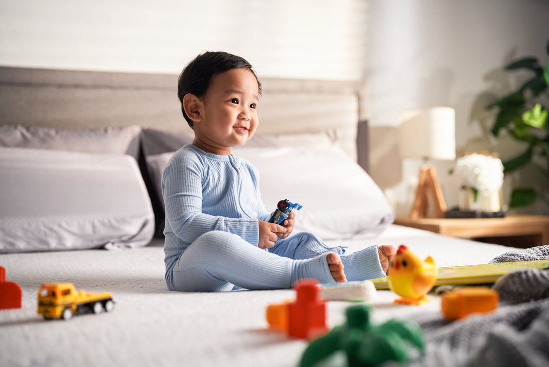 Toddler playing with toys happily on top of Good Knight Mattress