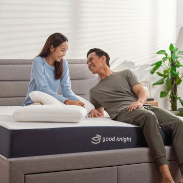 Happy couple moment on a Good Knight mattress: The couple is enjoying a moment of intimacy and togetherness as they glaze lovingly into each other's eyes. 