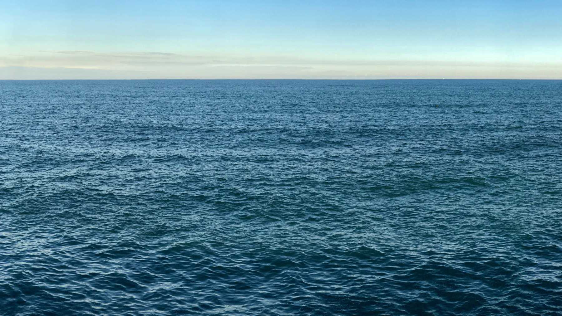 Seascape with sea horizon and clear blue sky